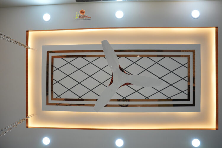 Ceiling design with geometric patterns and recessed lighting.