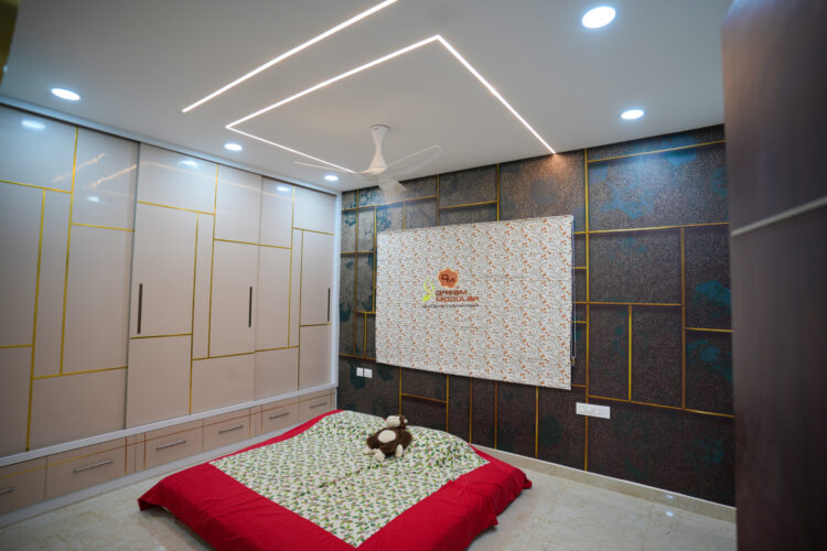 Modern bedroom interior with led ceiling lighting, a large bed with a red base, and built-in Sliding wardrobes with Golden T Stripes.