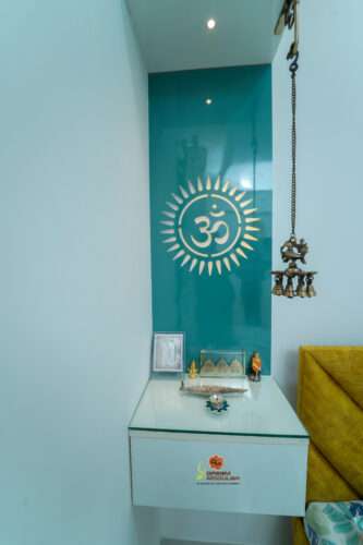 Pooja Unit with blue back panel with lite golden OM symbol and a storage cabinets - Dream Modular